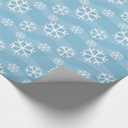 Weiße Schneeflocken auf blau Geschenkpapier (Ecke)