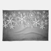 Weiße Schneeflocken auf grauem Küchentuch (Horizontal)