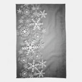 Weiße Schneeflocken auf grauem Küchentuch (Vertikal)