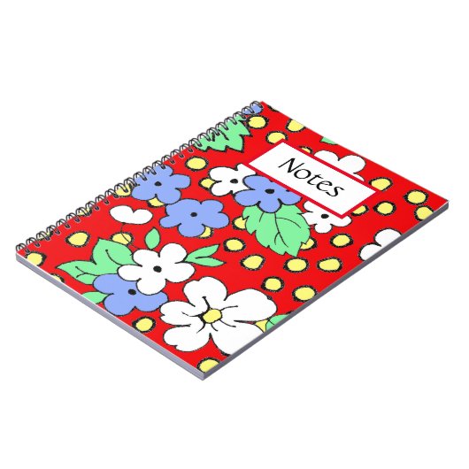 Weiße und blaue Blumen auf einem roten Spiralheft Notizblock (Linke Seite)