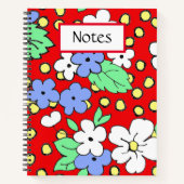 Weiße und blaue Blumen auf einem roten Spiralheft Notizblock (Vorderseite)