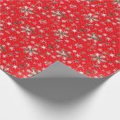 Weiße und grüne Schneeflocken auf einem roten Geschenkpapier (Ecke)