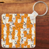 Weiße und Ingwer Katzen Muster grüne Augen blaue A Schlüsselanhänger (Rückseite)