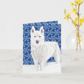 Weißer Husky gegen Schneeflocken und dunkelblauer  Karte (Gelbe Blume)