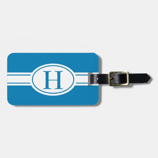 Weißes Band und ovales Schild mit Monogramm auf bl Gepäckanhänger (Vorderseite horizontal)