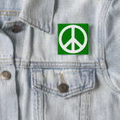 Weißes Friedenssymbol auf grünem Hintergrund Button (Beispiel)