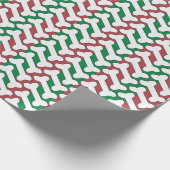 Weißes Knochenmuster auf rot und grün Geschenkpapier (Ecke)