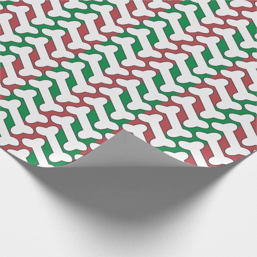 Weißes Knochenmuster auf rot und grün Geschenkpapier (Ecke)