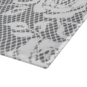 Weißes Spitzemuster auf grauem Hintergrund Schneidebrett (Ecke)