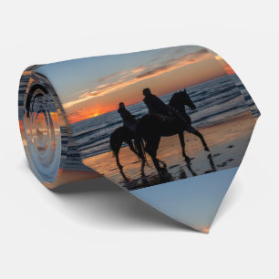 Western Paar Reitet auf dem Strand bei Sonnenunter Krawatte