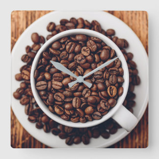 White cup full of roasted coffee beans quadratische wanduhr
