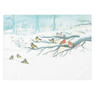 Wintervögel in einem schneebedeckten Wald an einem Tischdecke