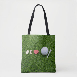 Wir Liebe Golf mit Golfball und Tee auf grünem Gr Tasche