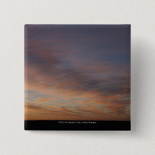 Wolken in einem orange Himmel am Sonnenaufgang Button