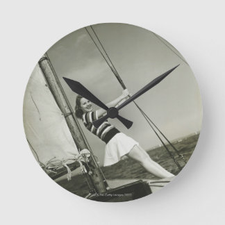 Woman Holding Rigging on Yacht Runde Wanduhr
