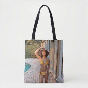 Woman in yellow bikini standing on brown brick flo tasche