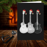 Xmas Gitarre Santa Black und White Karte<br><div class="desc">Weihnachten Schwarz und Weiß Elektrische Gitarre Art festliche Grüße Karte. Diese einfarbige Gitarrenkunst mit lustigen Weihnachtsmannmützen-Grußkarten ist ideal für Musikliebhaber, besonders für Jugendliche. Sie können einen persönlichen Gruß oder Slogan hinzufügen, um eine personalisierte Weihnachtsgrüßkarte zu erstellen. Minimalistische Kunstzeichnungen von drei Gitarren in durchsichtiger und ätherischer Schwarz-Weiß, ergänzt mit Weihnachtsmannmützen von...</div>