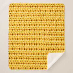 Yellow knitted woolen fabric background sherpadecke
