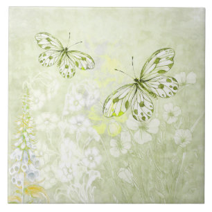 Zarte weiße Schmetterlinge auf weichen grünen Flie Fliese