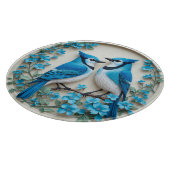 Zwei blaue Jay, die auf einer Zweigstelle stehen Schneidebrett (Ecke)