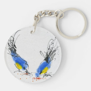 Zwei kleine titmouses, die Korn pecking sind. Schlüsselanhänger