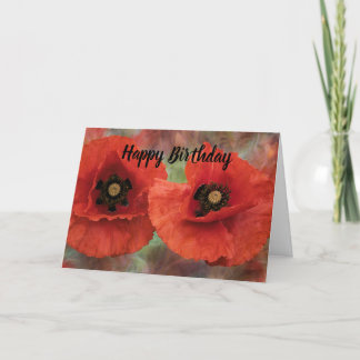 Zwei rote Pupien auf einem texturierten Hintergrun Feiertagskarte