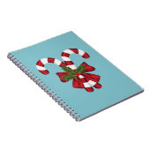 Zwei rote und weiße, festliche Süßigkeiten auf bla Notizblock (Rechte Seite)