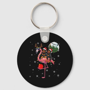 Zwei Rottweilers, die Flamingo Reindeer Sung Schlüsselanhänger