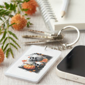 Zwei Schädel und ein Kürbis unter den Blume. Schlüsselanhänger (Vorderseite rechts)