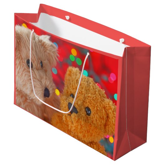 Zwei Teddybären mit Weihnachtsbeleuchtung Große Geschenktüte (Vorderseite Schrägansicht)