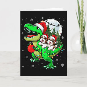 Zwei Weihnachts-Shih-Tzus reiten T-Rex-Rentier Lie Karte